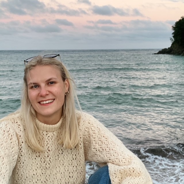 India Golding on a beach at sunset