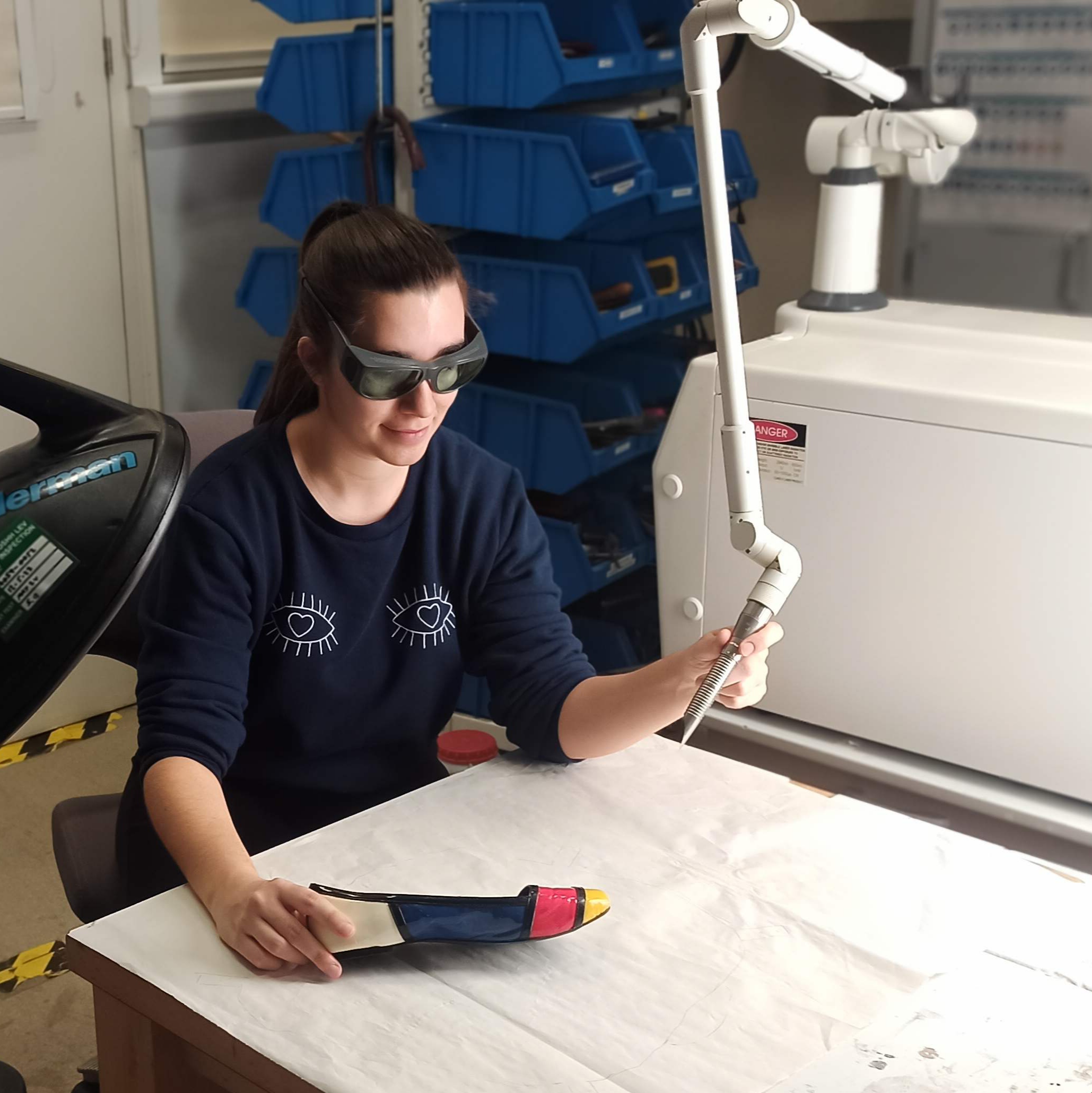 Julia Brand preparing to work on a multi-coloured shoe