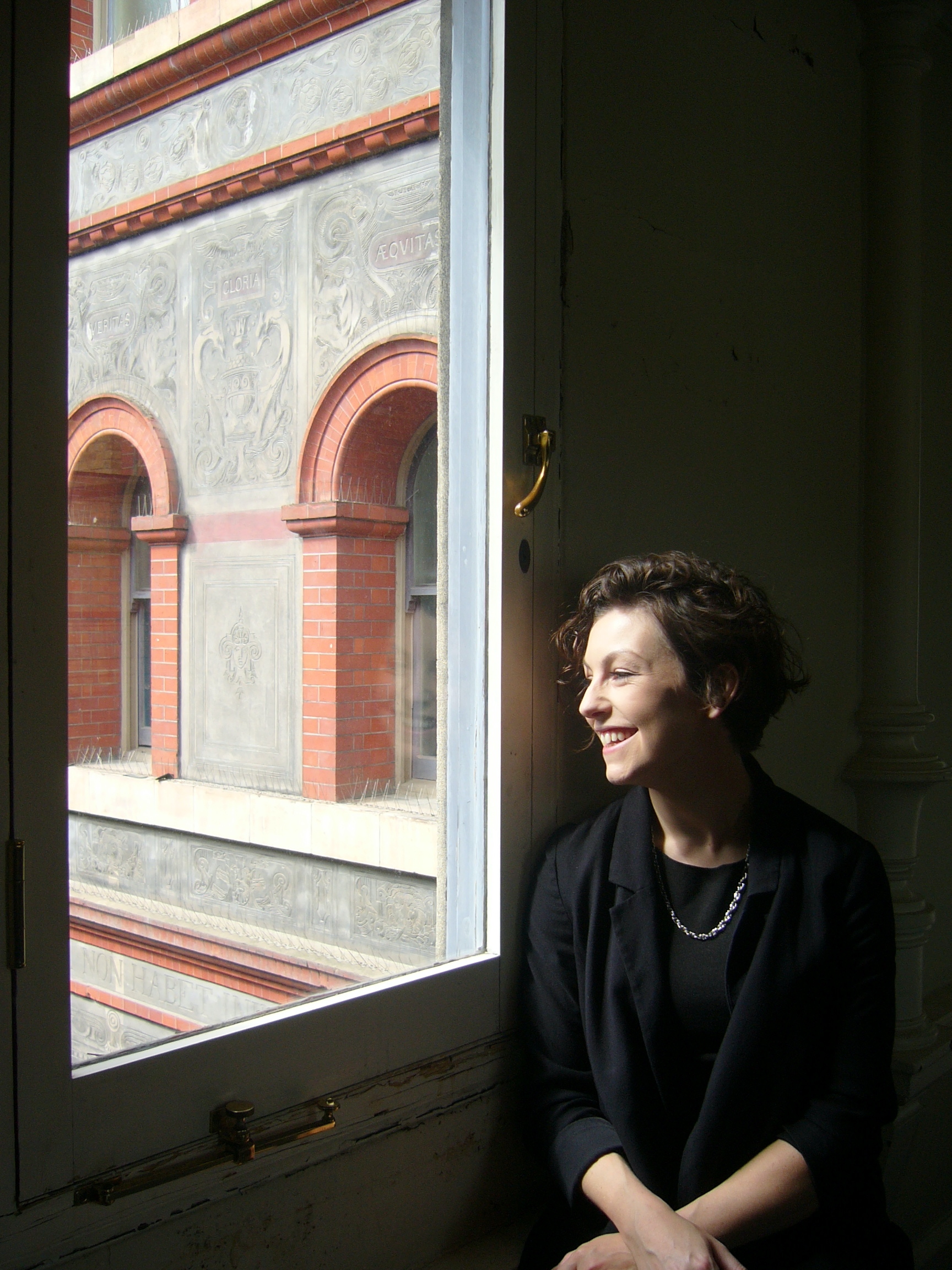 Katherine Mitchell looking out of a window at the V&A