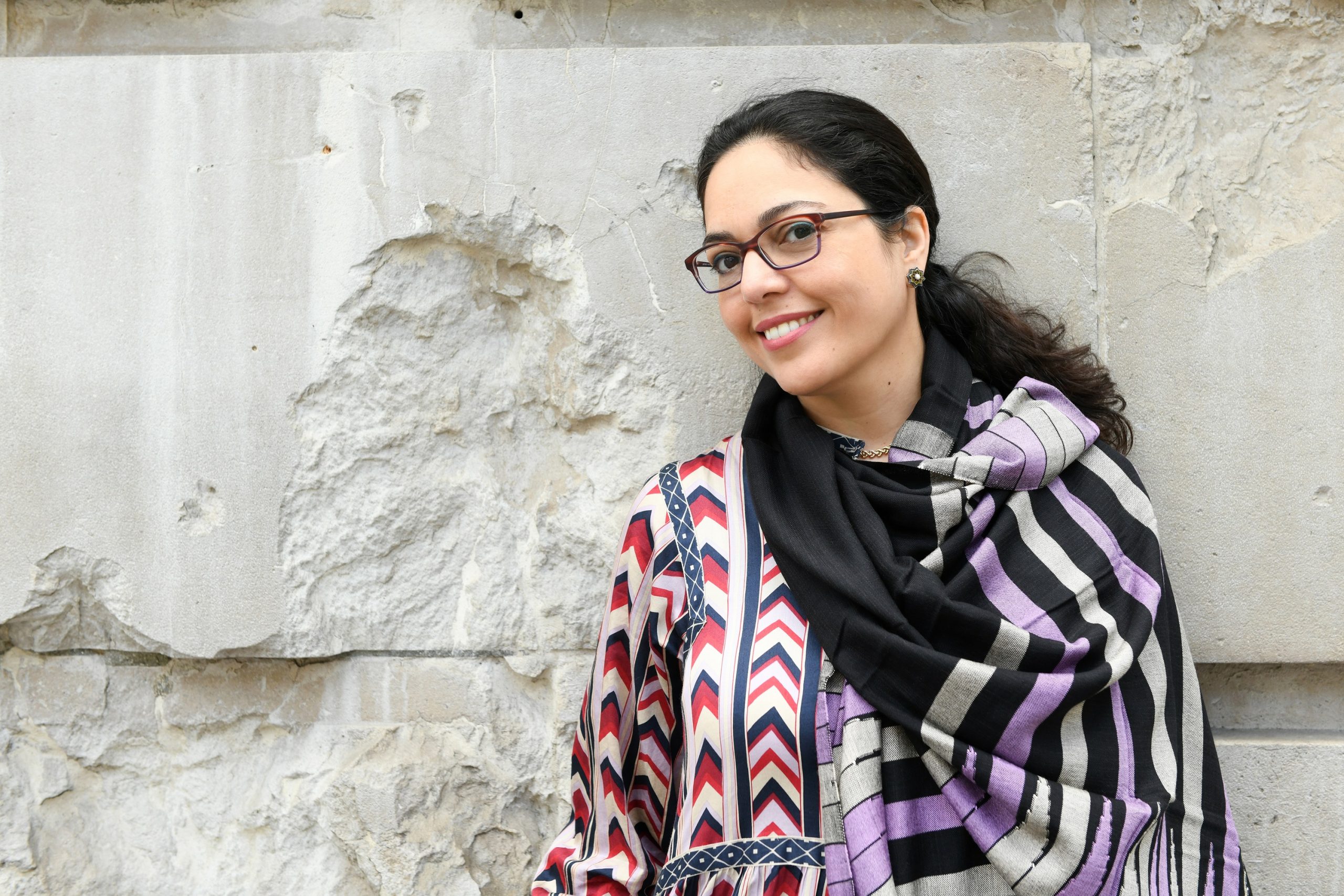 Omniya Abdel Barr against a stone wall