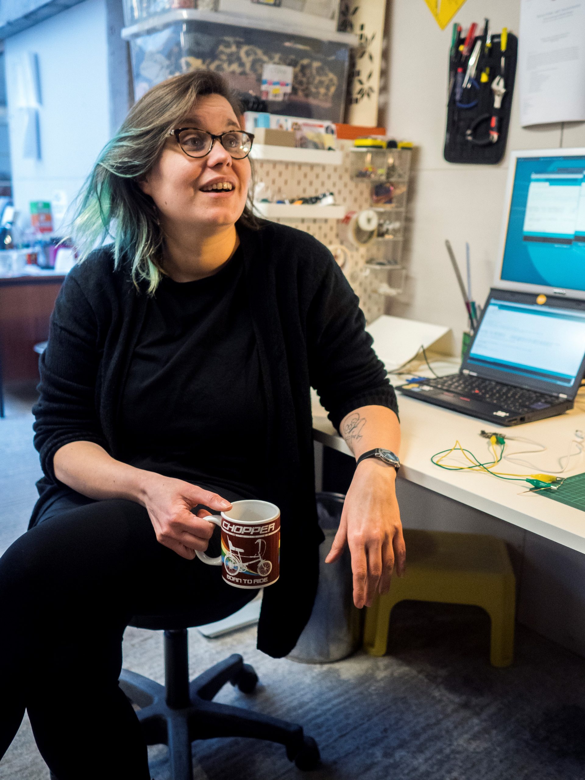 Toni Buckby sitting with a cup of coffee