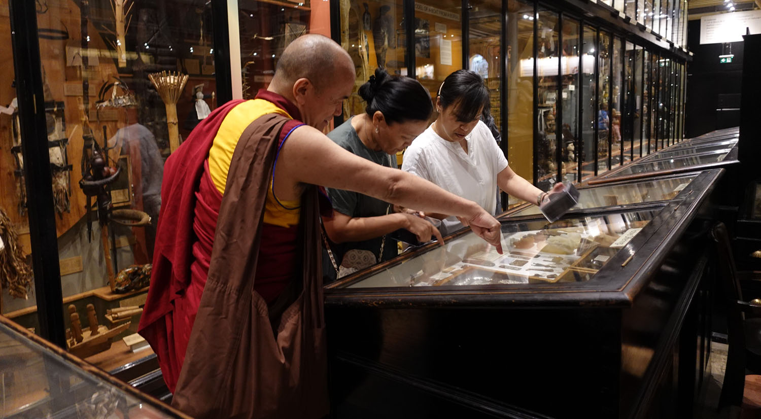 Visitors looking at objects at the Pitt Rivers Museum in Oxford